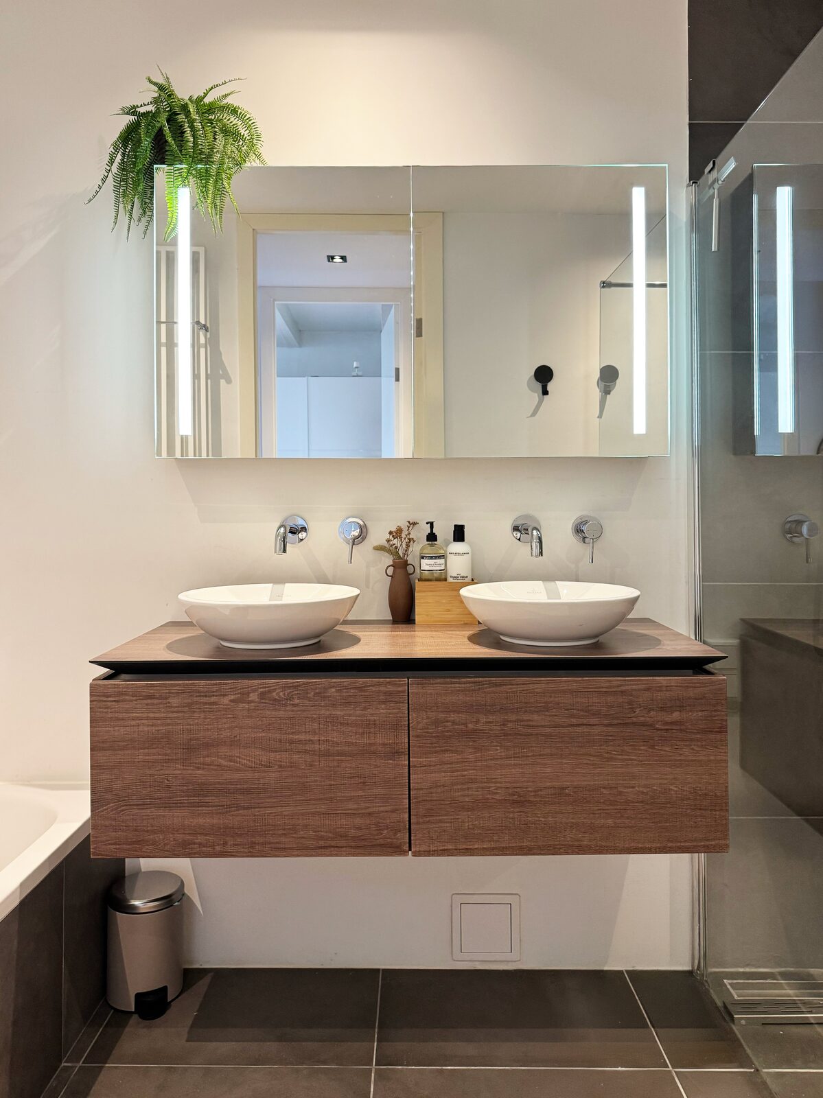 Spa bathroom at Waal with a double vanity, twin basins, mirrored cabinets and a walk-in rain shower