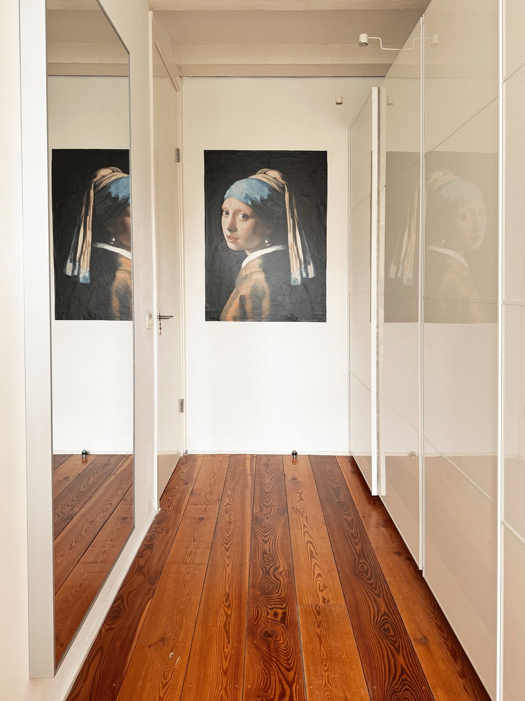 The dressing hall at Waal with a Girl with a Pearl Earring tapestry, a full-length mirror and reclaimed pine floors
