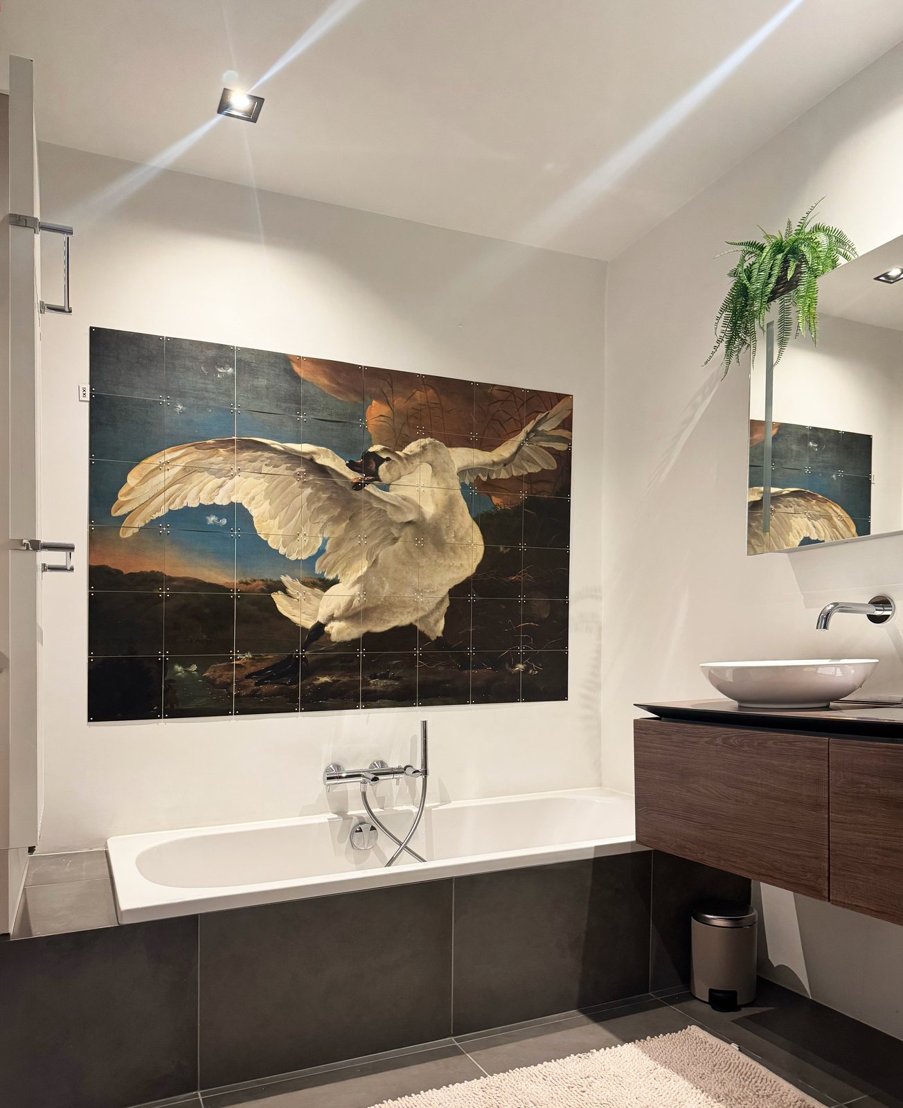 The main bathroom at Waal, with a large painting of a swan filling the wall above the bath